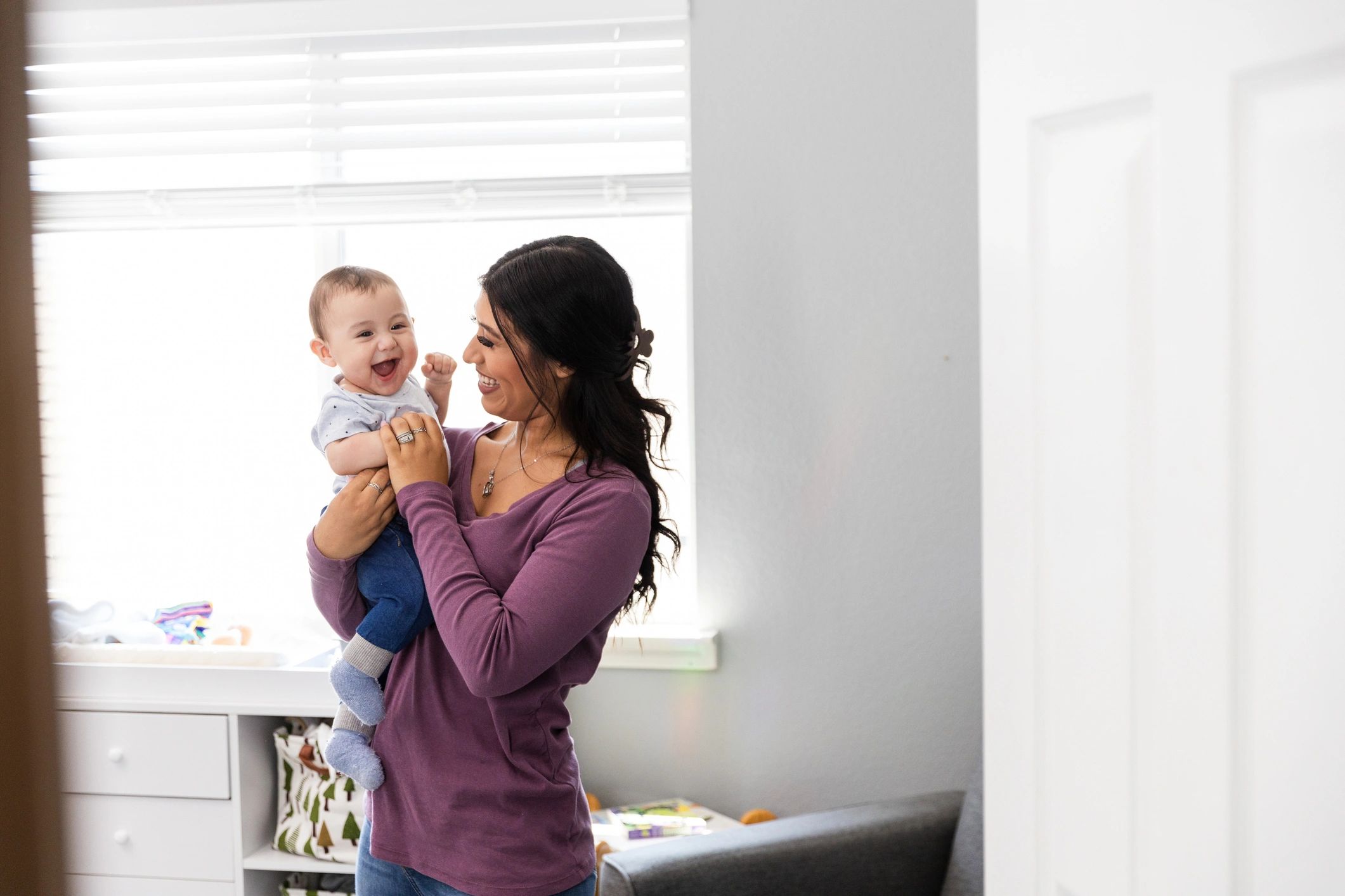 Smiling baby with mother during everyday family time