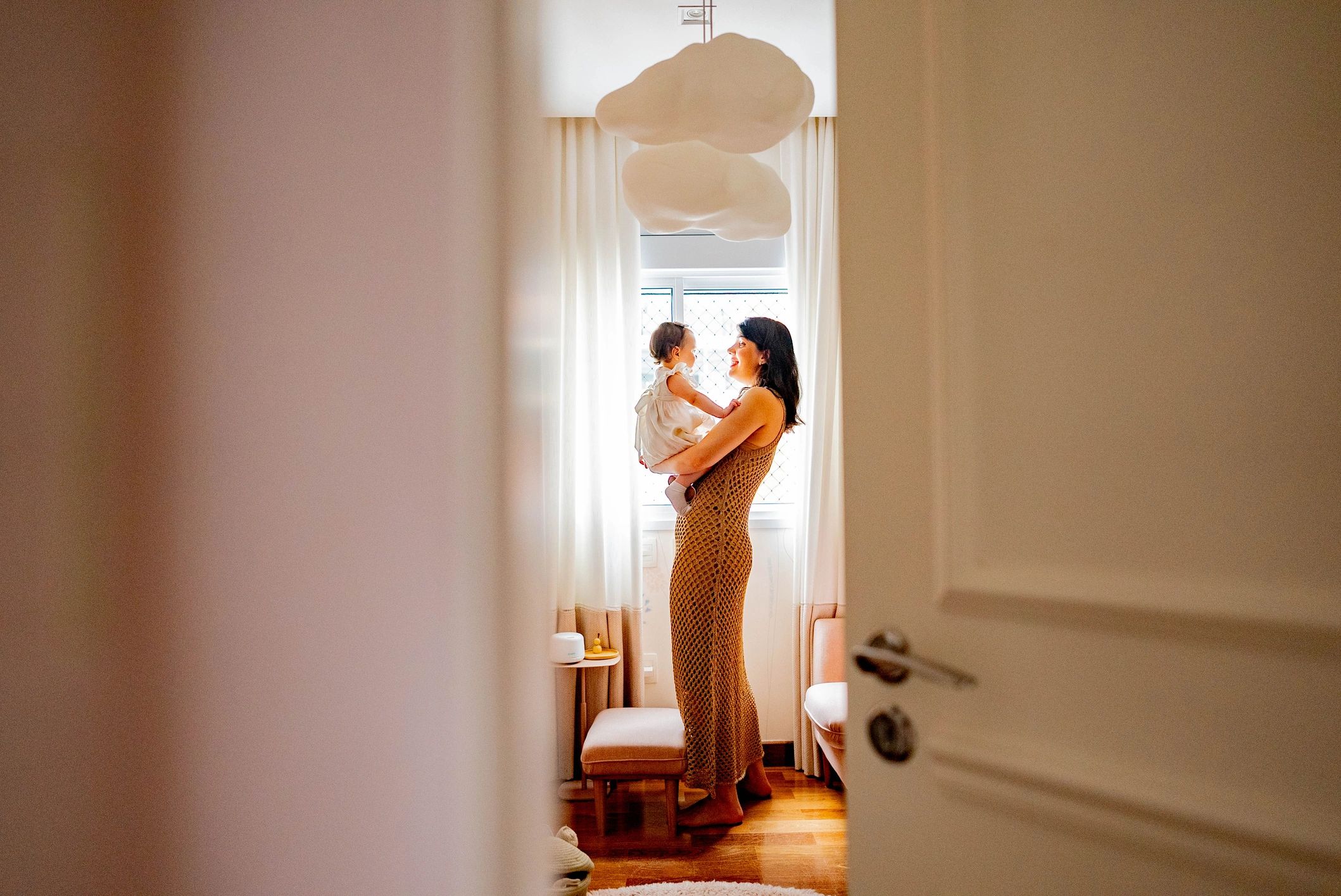 Mother holding her daughter at home