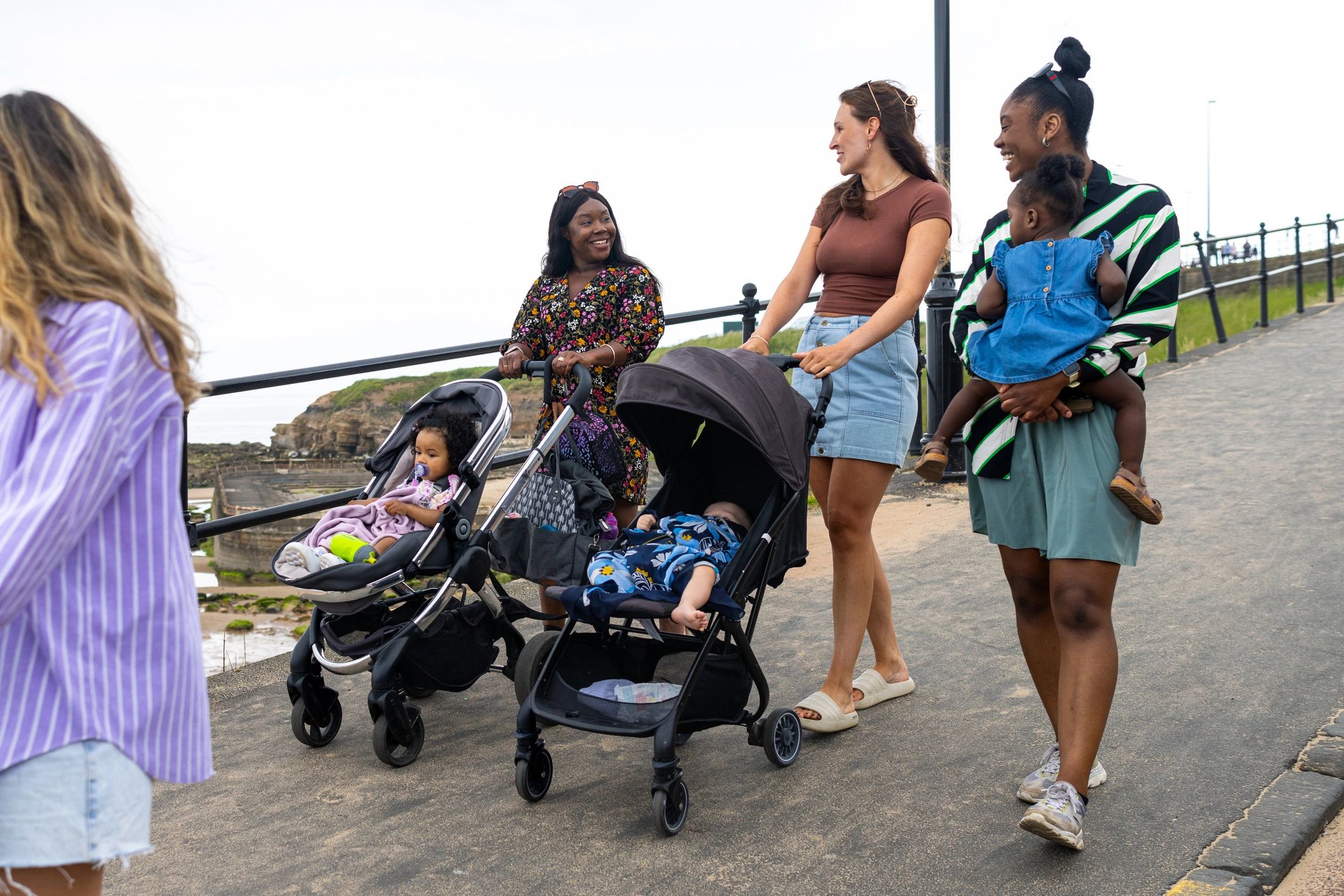 Group of mothers with young children outdoors
