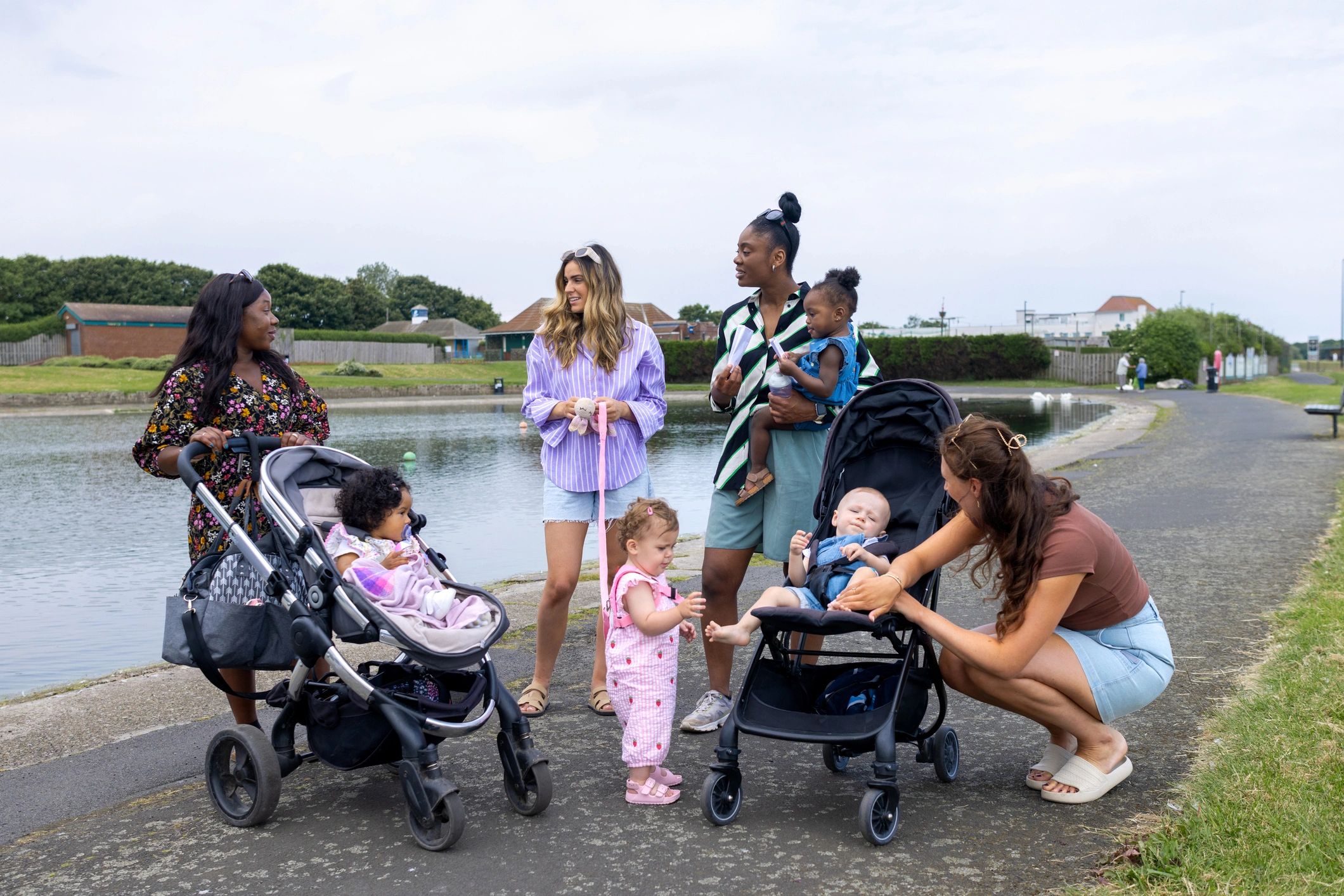 Mothers walking with babies in strollers